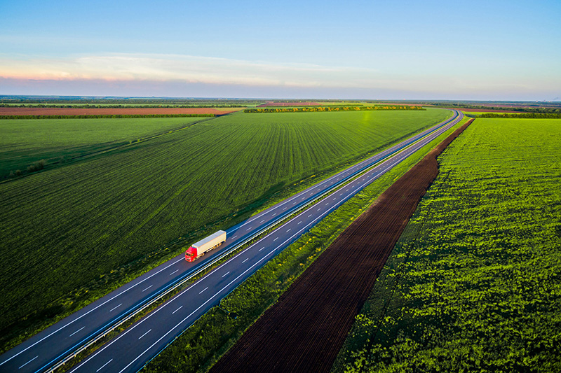 Truck driving among farms