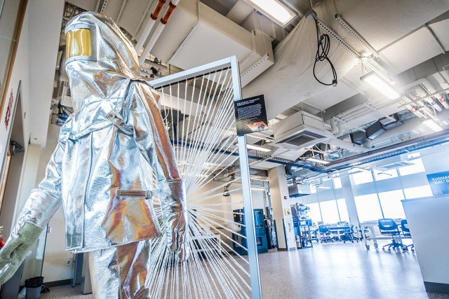 Silver high temperature protective body suit in a lab.