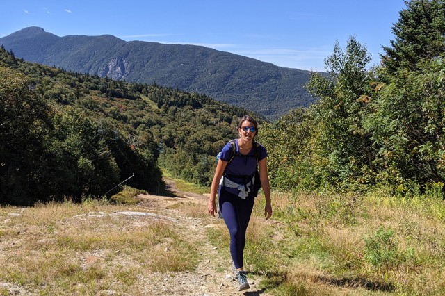 woman on a hiking trail in the mountains.