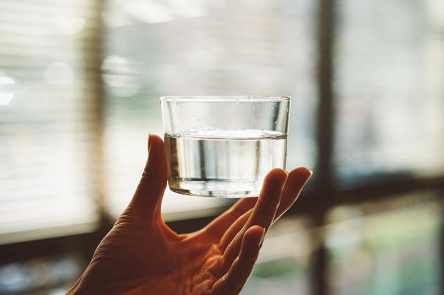 hand holding a glass of water.