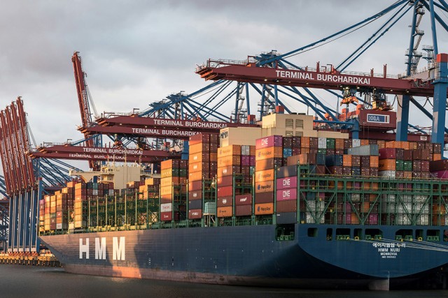 a large cargo ship waits at port.