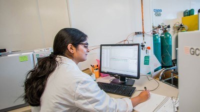 Researcher analyzing data on a computer.