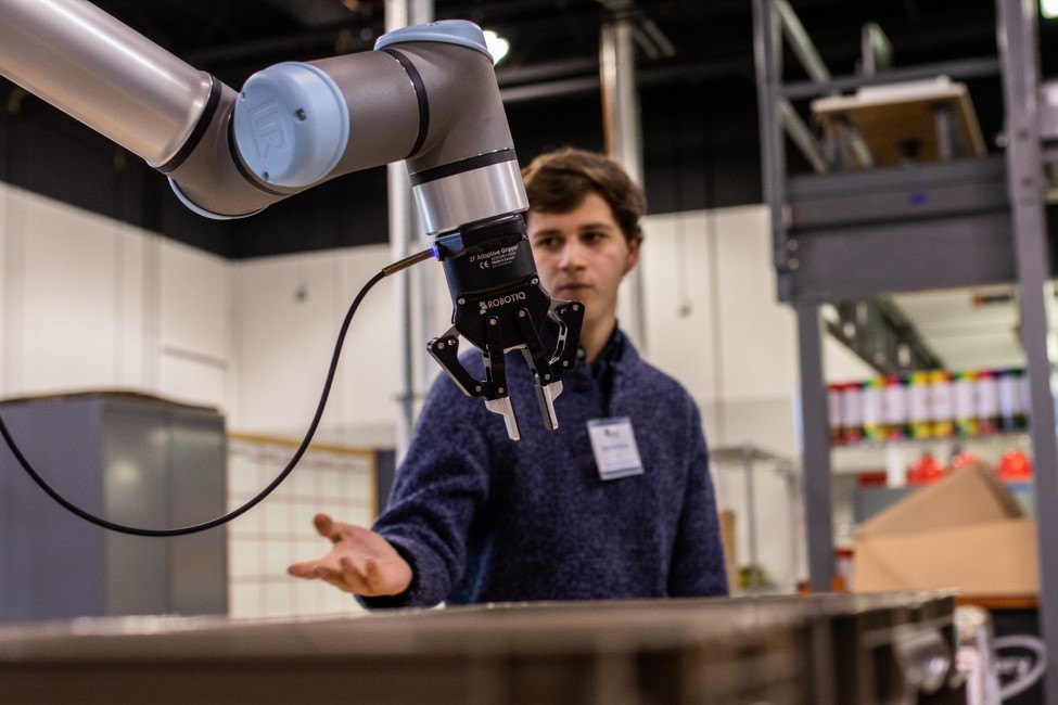 staff showing how cobot works