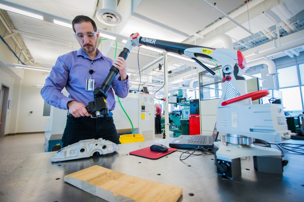 Digital manufacturing lab rover arm being handled by staff