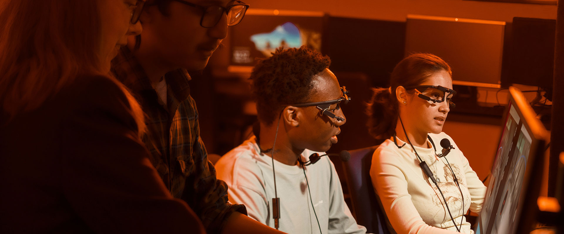2 researchers wearing eye-tracking glasses in a lab.