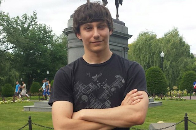 Student posing in front of statue