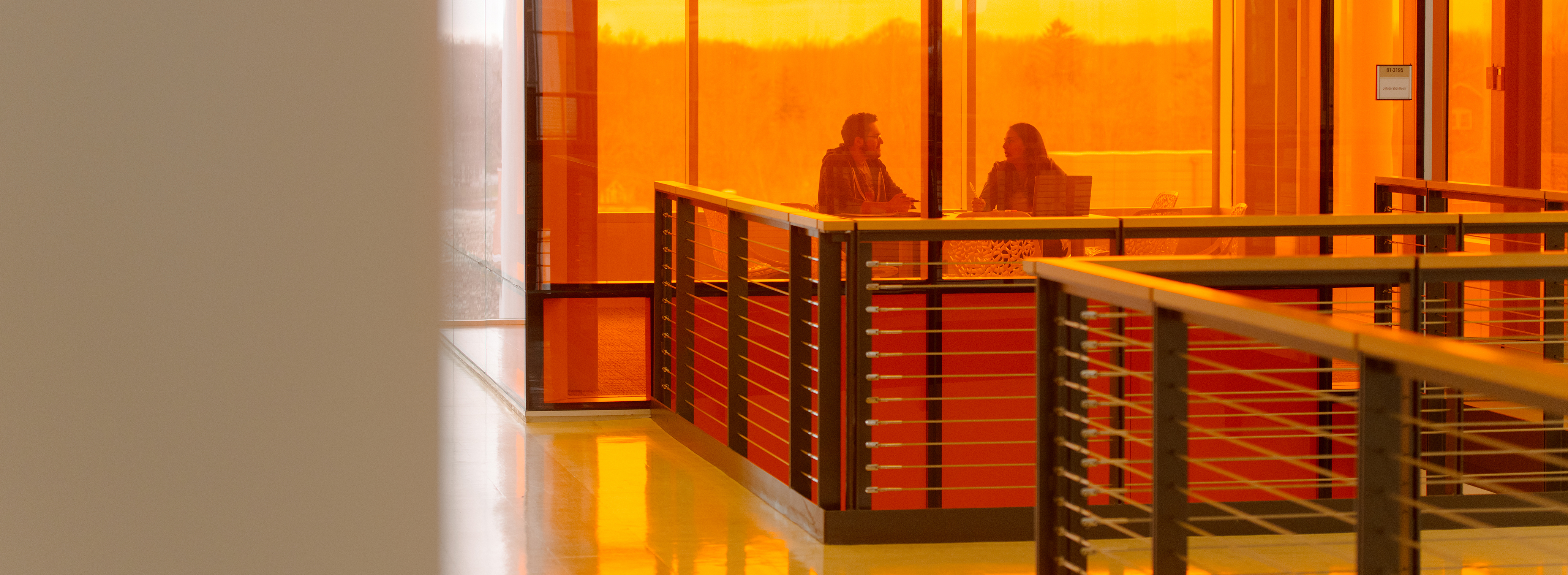 Two people talking in an office.