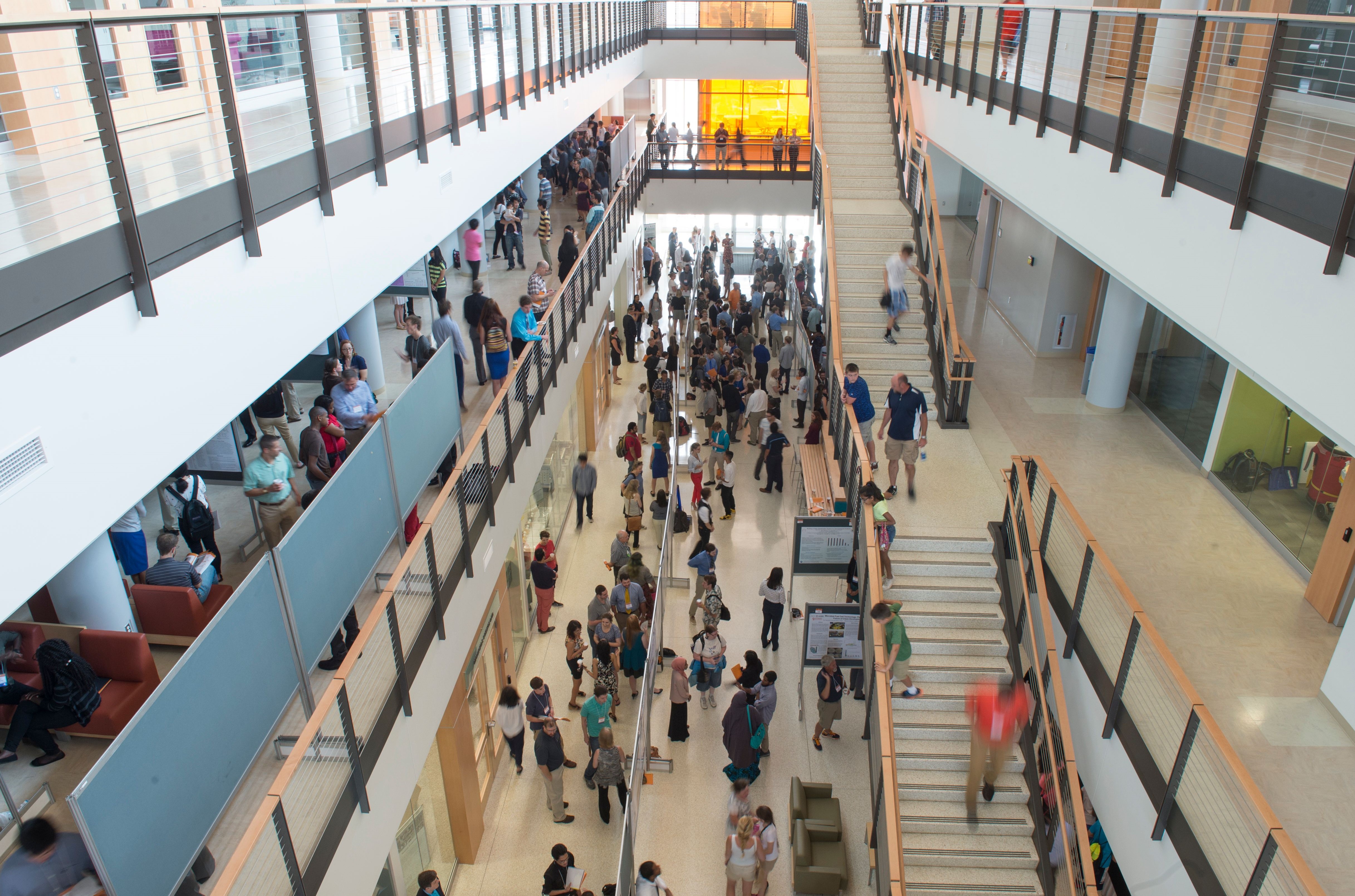 Many people moving through a building on campus