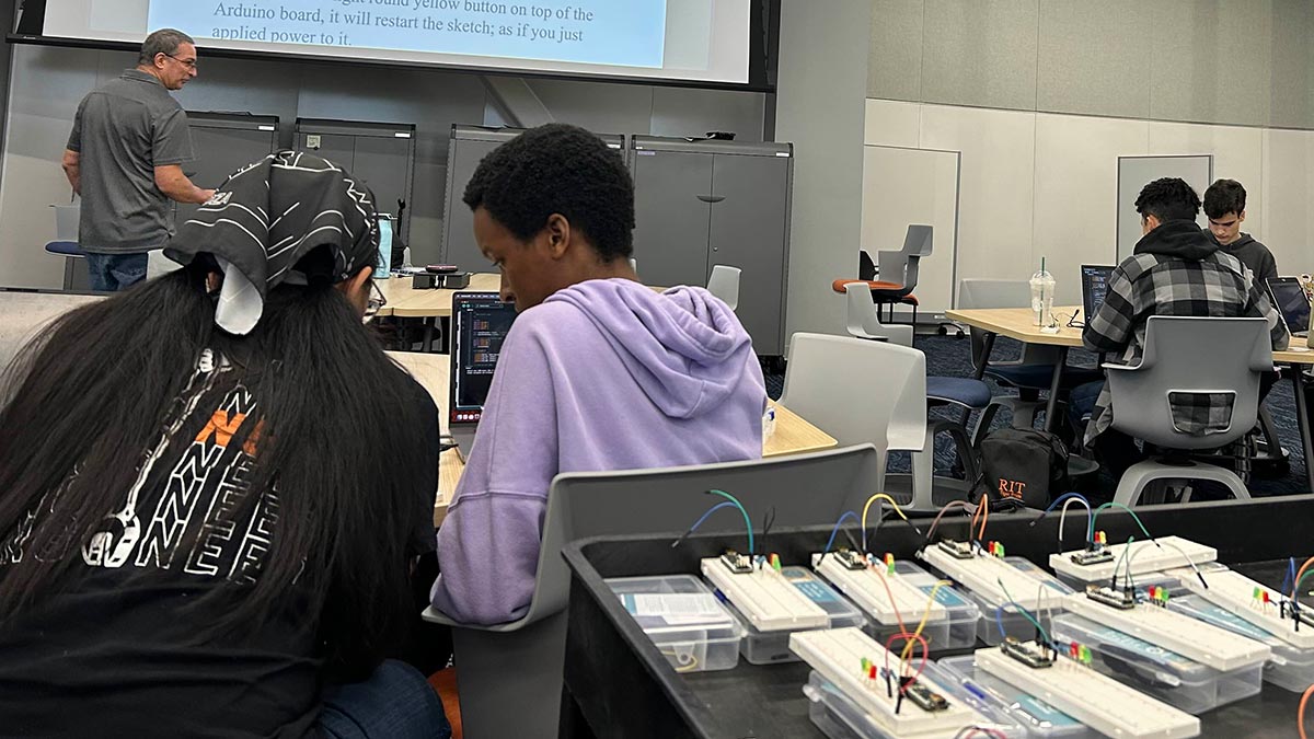 students at tables working in pairs.