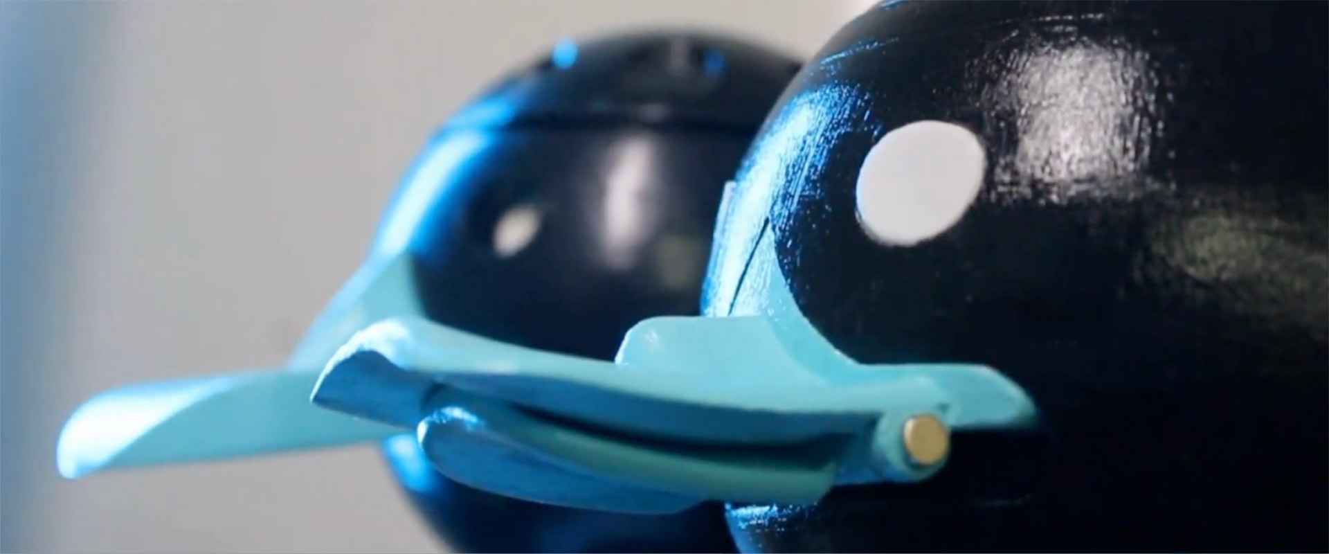 a close-up of black and light blue 3-D printed ducks.