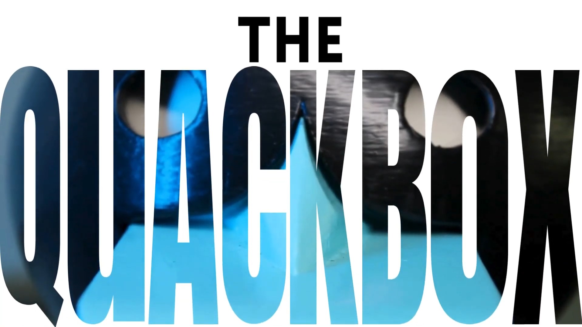 A white screen displaying the text "The Quackbox" with the face of a duck in the background