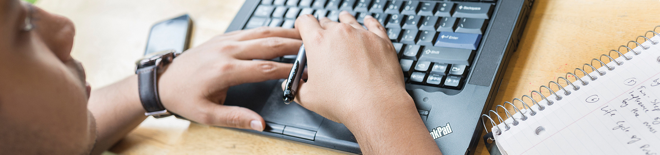 Male student using a laptop