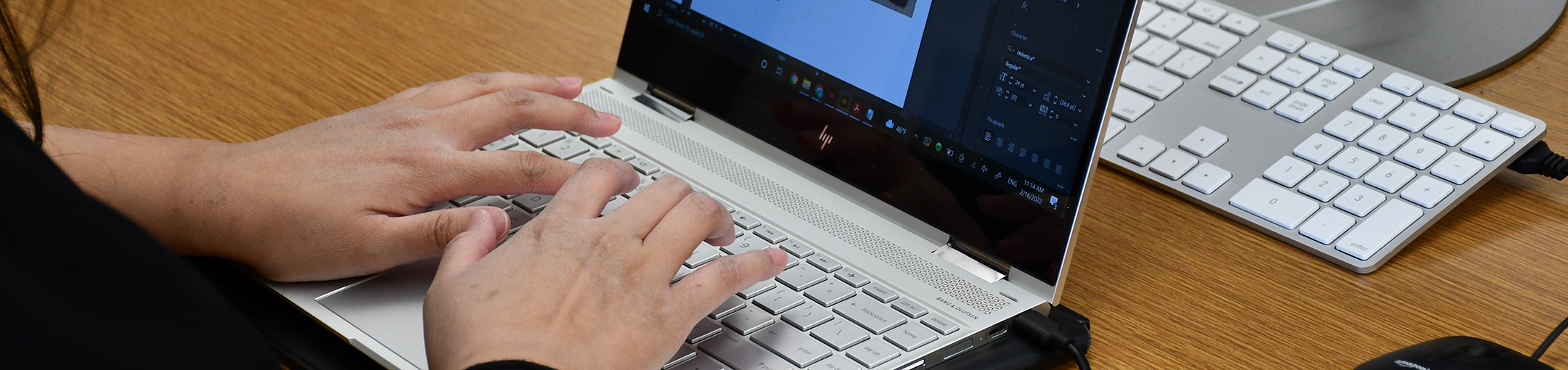 hands using a laptop computer.