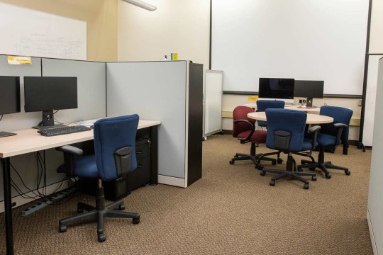Cubicles with computer workstations and a small round table