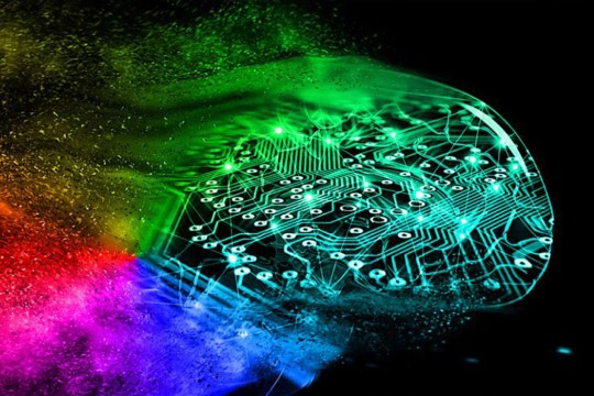 A color burst of red, pink, blue, and green, merging into a network of dots and lines that mimic a circuitboard.