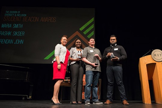 People gathered for picture on stage of the "Student Beacon Awards"