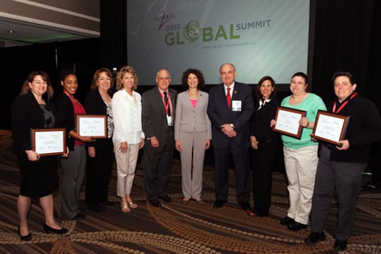 People posing with awards at event