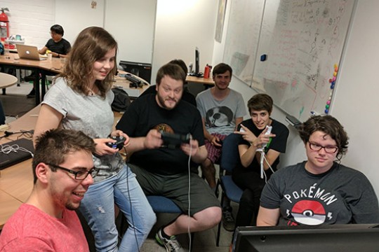 Team gathered around television