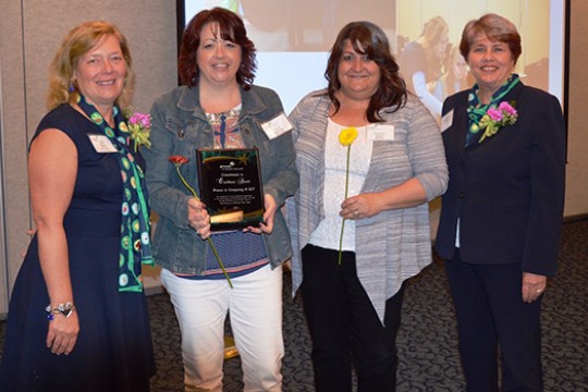 People gathered at event with award