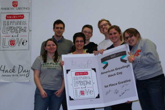 People posing with award certificate