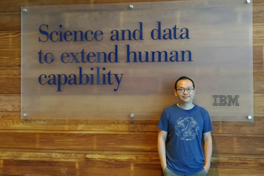 Person posing in front of IBM sign 