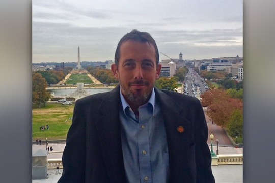 Director posing for picture on staircase