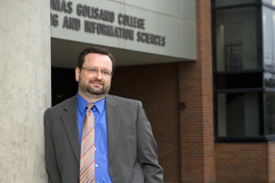 Person posing for camera outside building