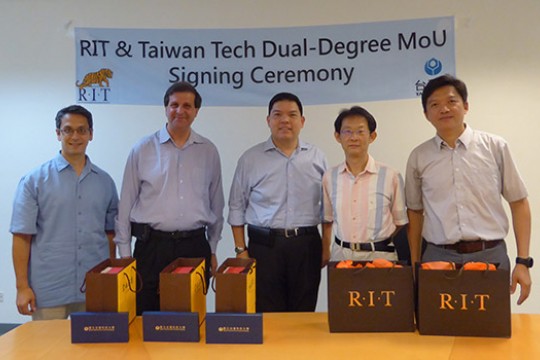 Five professors posing in front of "RIT & Taiwan Tech Dual-Degree MoU signing Ceremony"