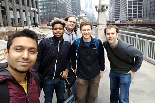 People gathered for picture on pathway in city