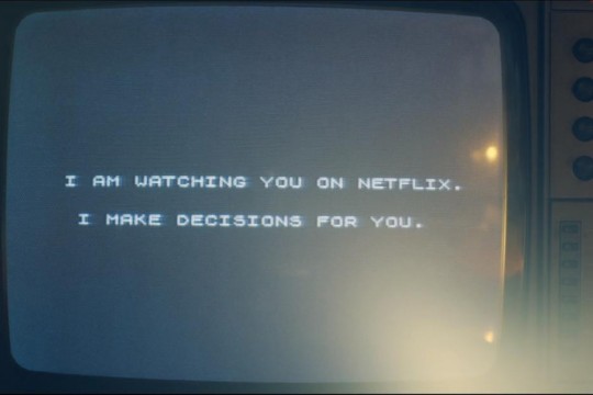 TV screen showing text: I am watching you on Netflix. I make decisions for you.