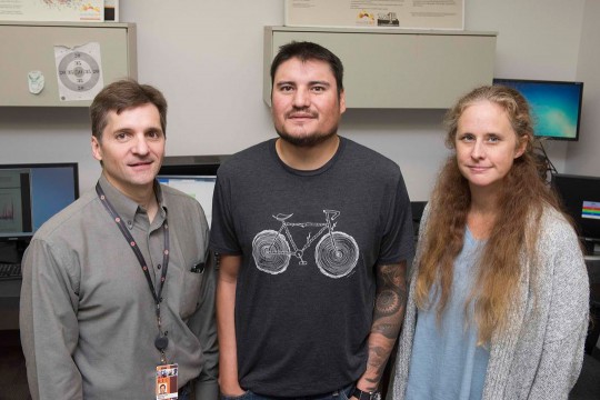Three researchers standing