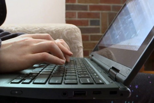 person typing on laptop.