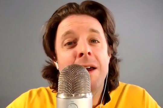 professor talking into a microphone.