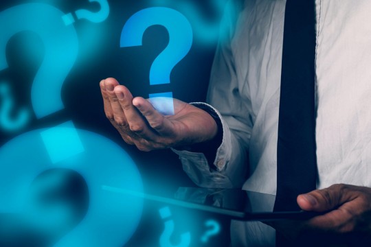 Hand holding a question mark graphic