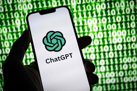a hand holding a smart phone displaying the Chat G P T logo.