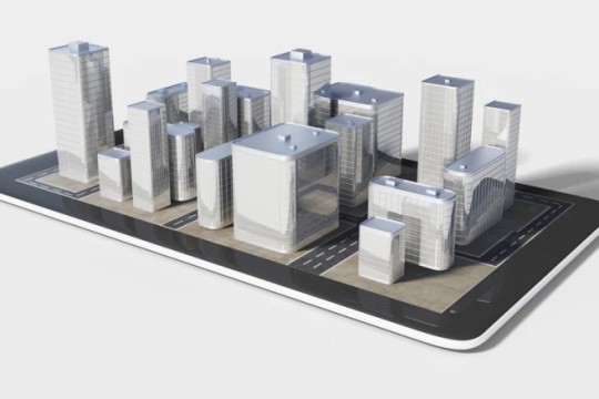 a virtual image of a city appearing to come out of the screen of an i pad