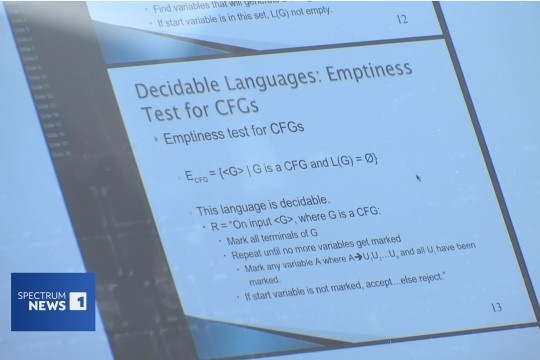 artificial intelligence and computer science concepts are displayed on a white board in a classroom.