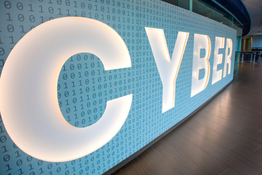 large backlit sign that says 'Cyber'