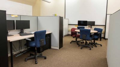 Cubicles with computer workstations and a small round table