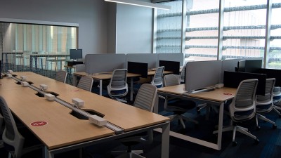 a lab with several workstations and a long table with outlets.