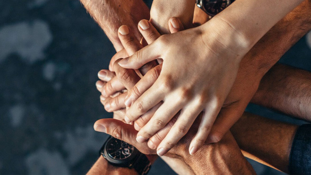 Several hands on top of each other.