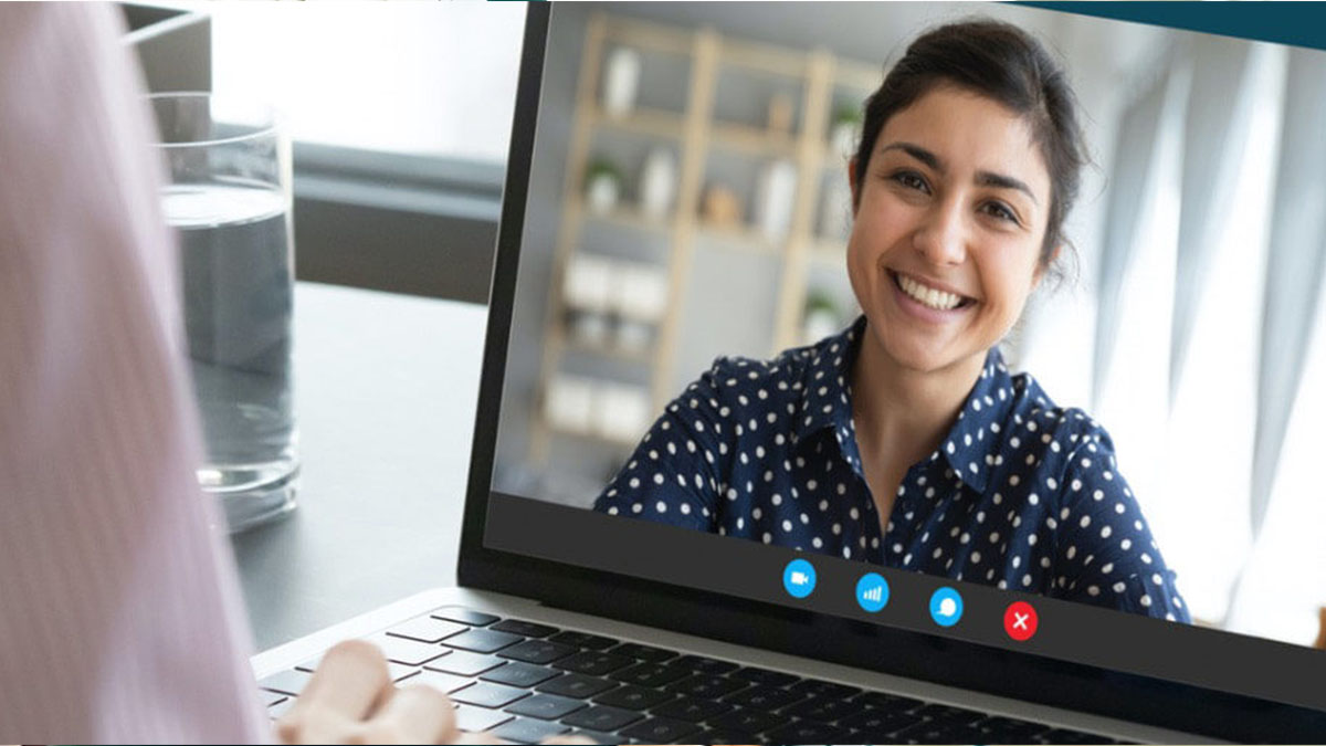 A person looking at a screen displaying the video feed of another person during a Skype video call.