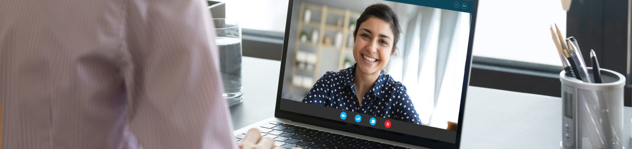 A person looking at a screen displaying the video feed of another person during a Skype video call.