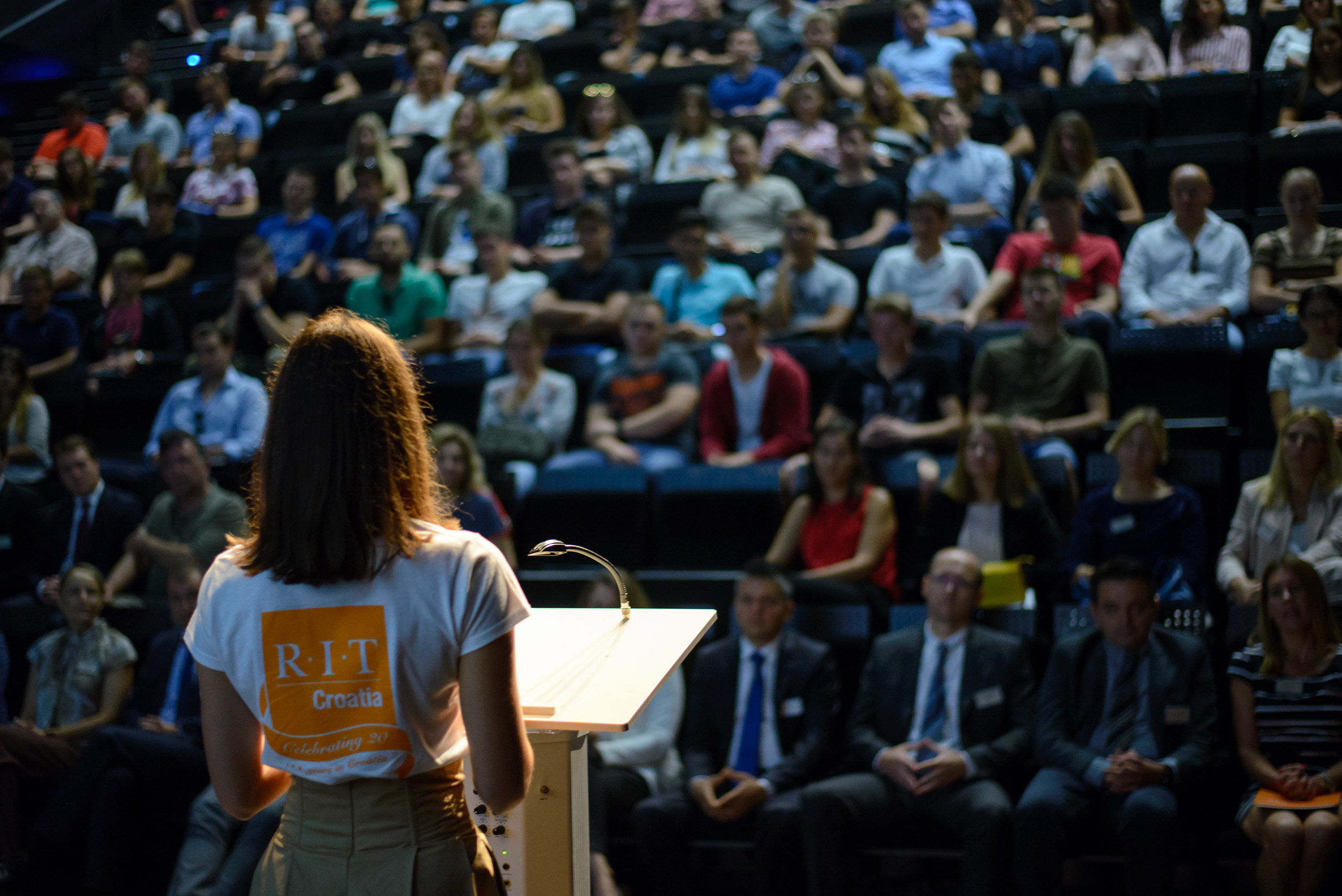Student speaking to a full auditorium