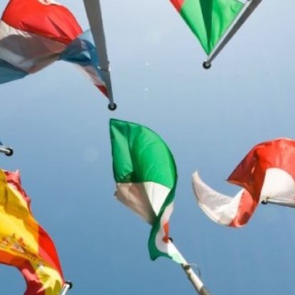 Student posing in front of flags