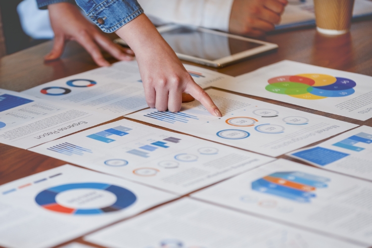 A hand pointing at chart on a paper