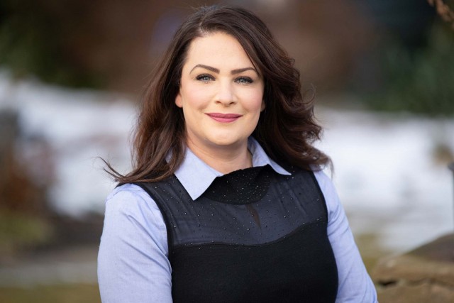 Woman in blue shirt smiles