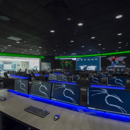 lab full of computers and large monitors on the walls.