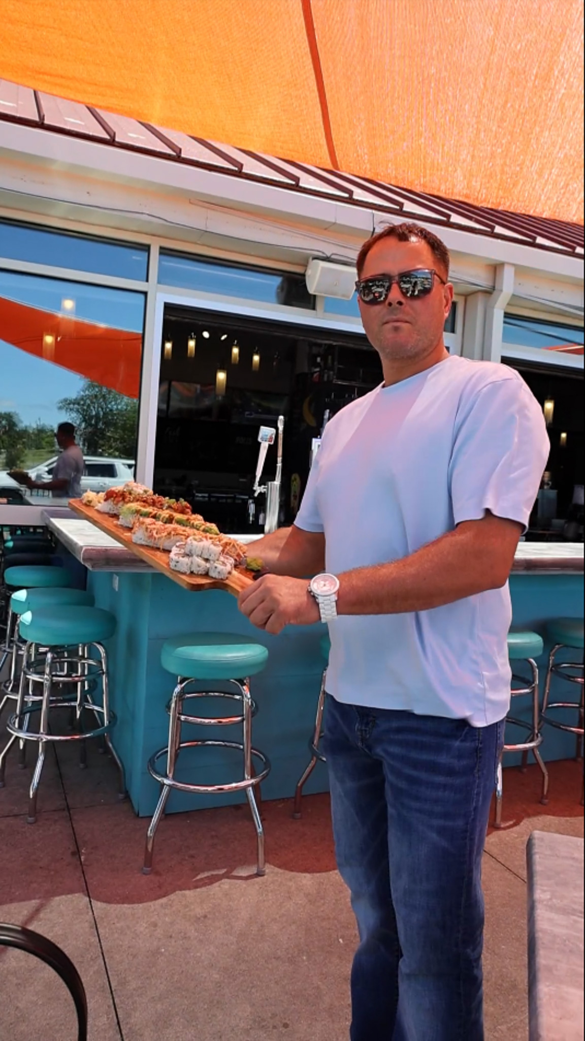 owner holding sushi