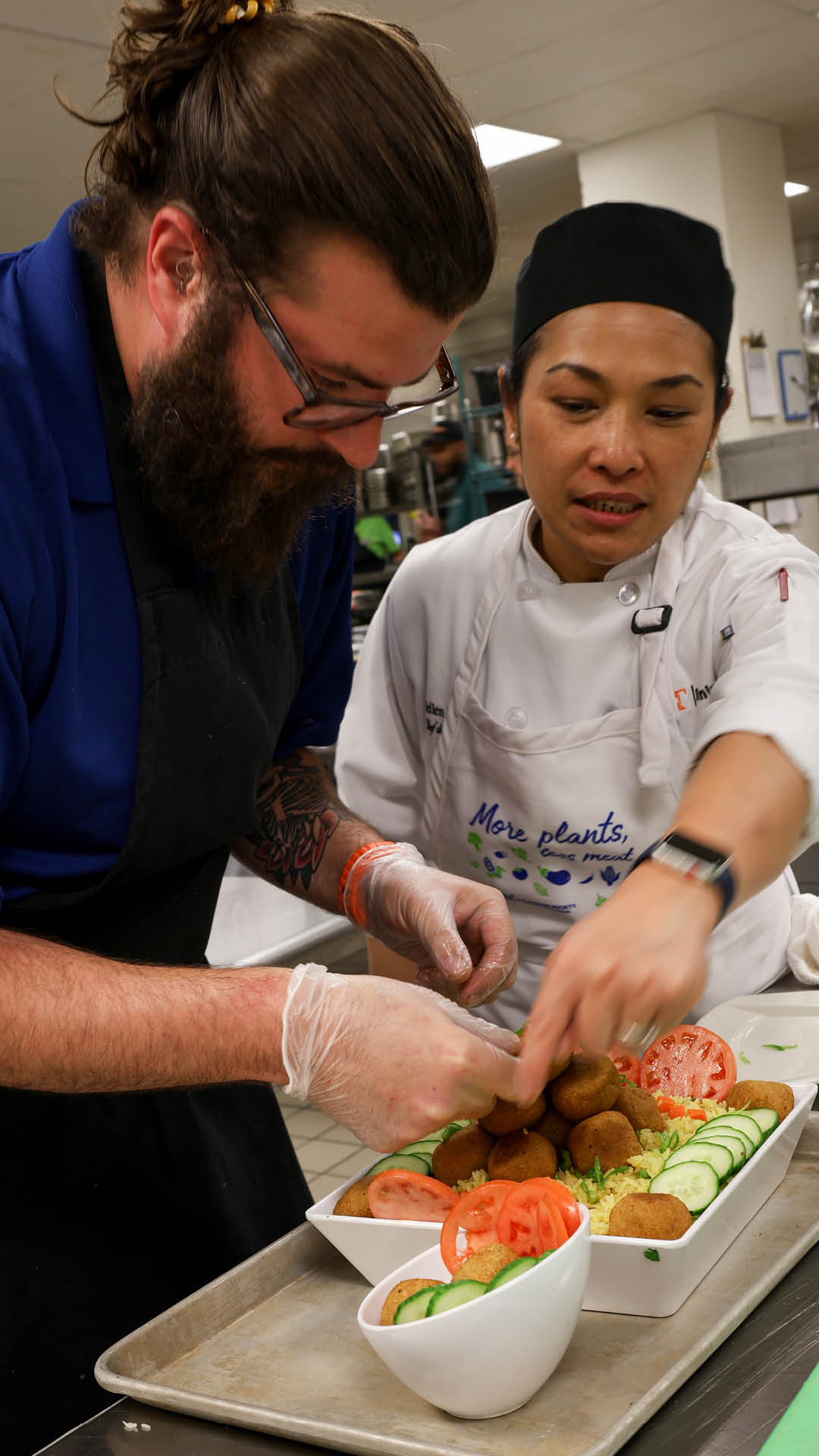two chefs in the kitchen cooking.